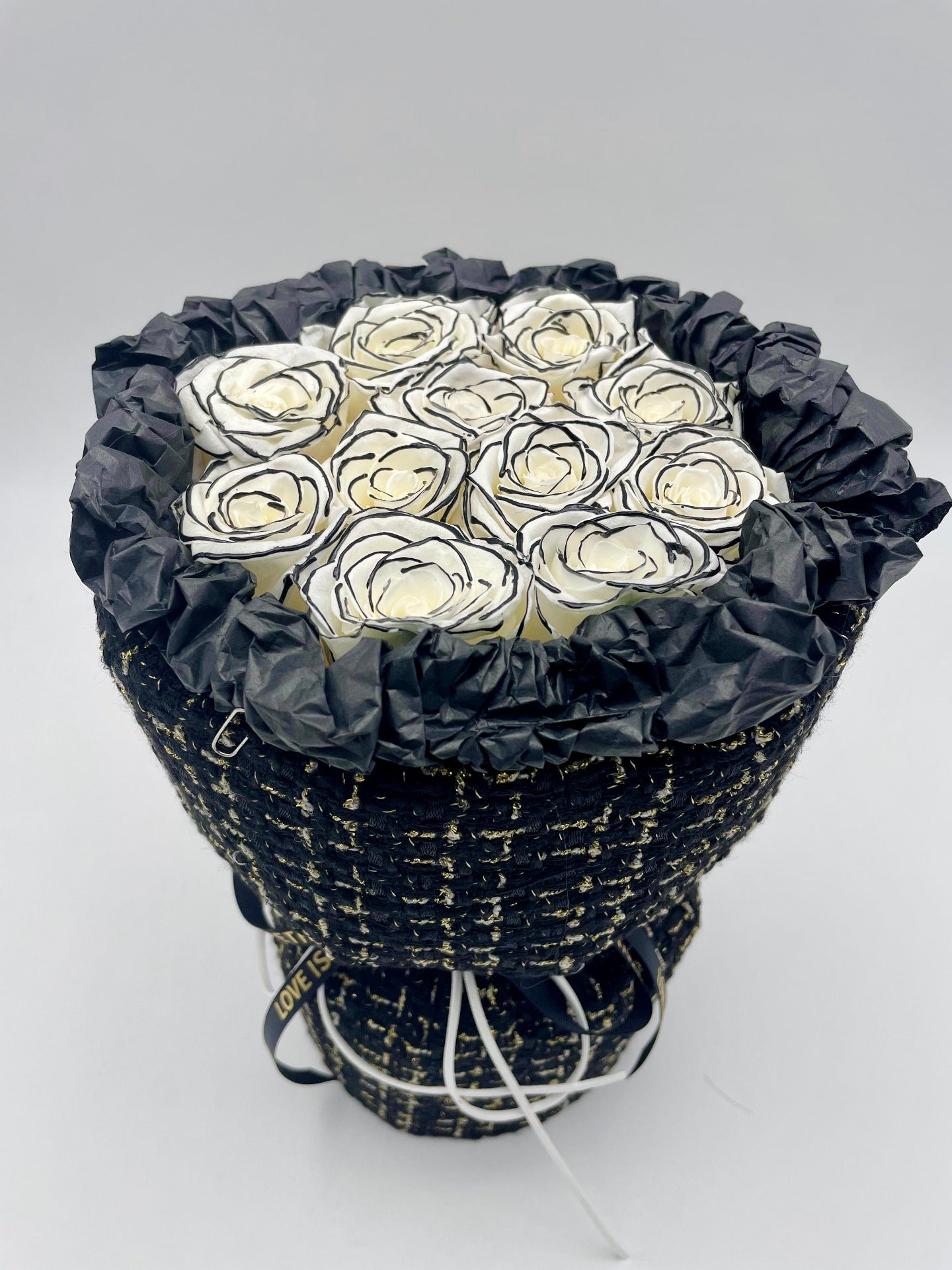 A bouquet of preserved white roses in a black box with white pattern of lines and dots. Available in Flowers Express Co in Melbourne.