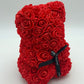 A beautifully crafted Rose Bear made of red roses, standing upright with a black ribbon around its neck, symbolizing love and beauty.