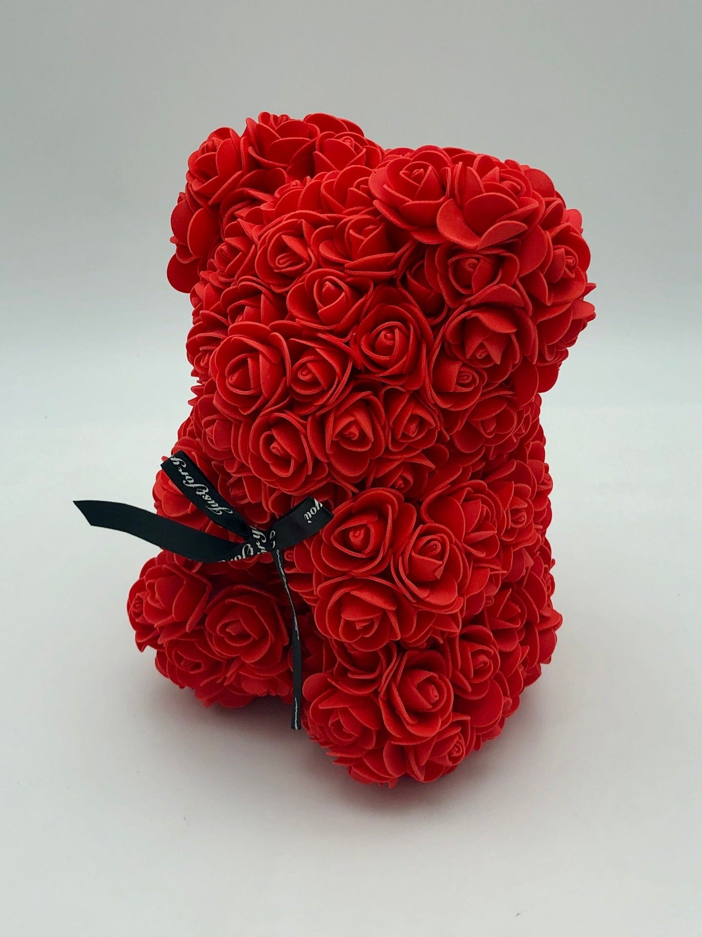 A teddy bear made of red roses, standing upright against a white background. Delivery by Flowers Express Co in Melbourne.