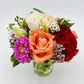 A stunning colourful bouquet in a mini vase. Available in Melbourne.