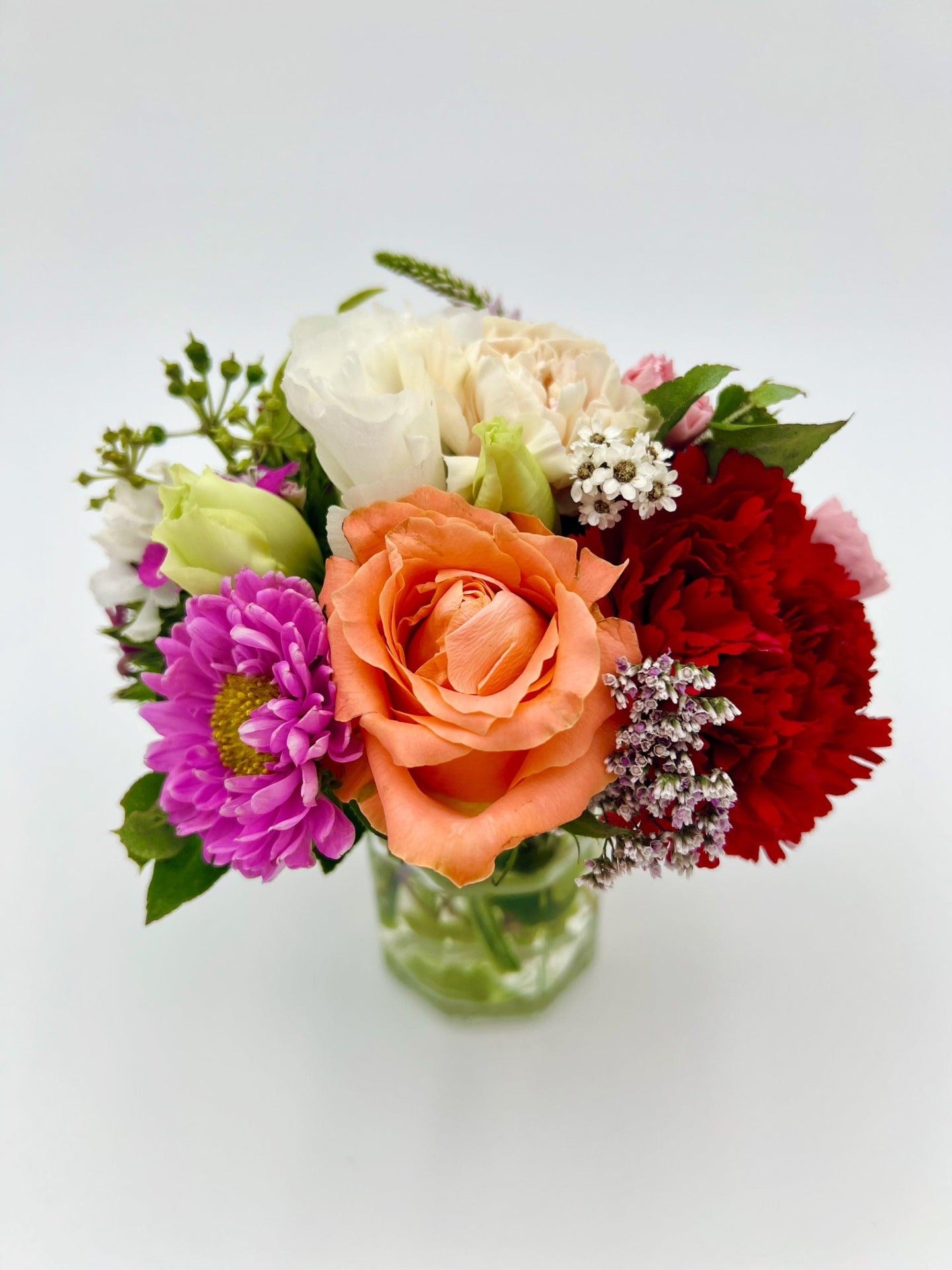 A stunning colourful bouquet in a mini vase. Available in Melbourne.