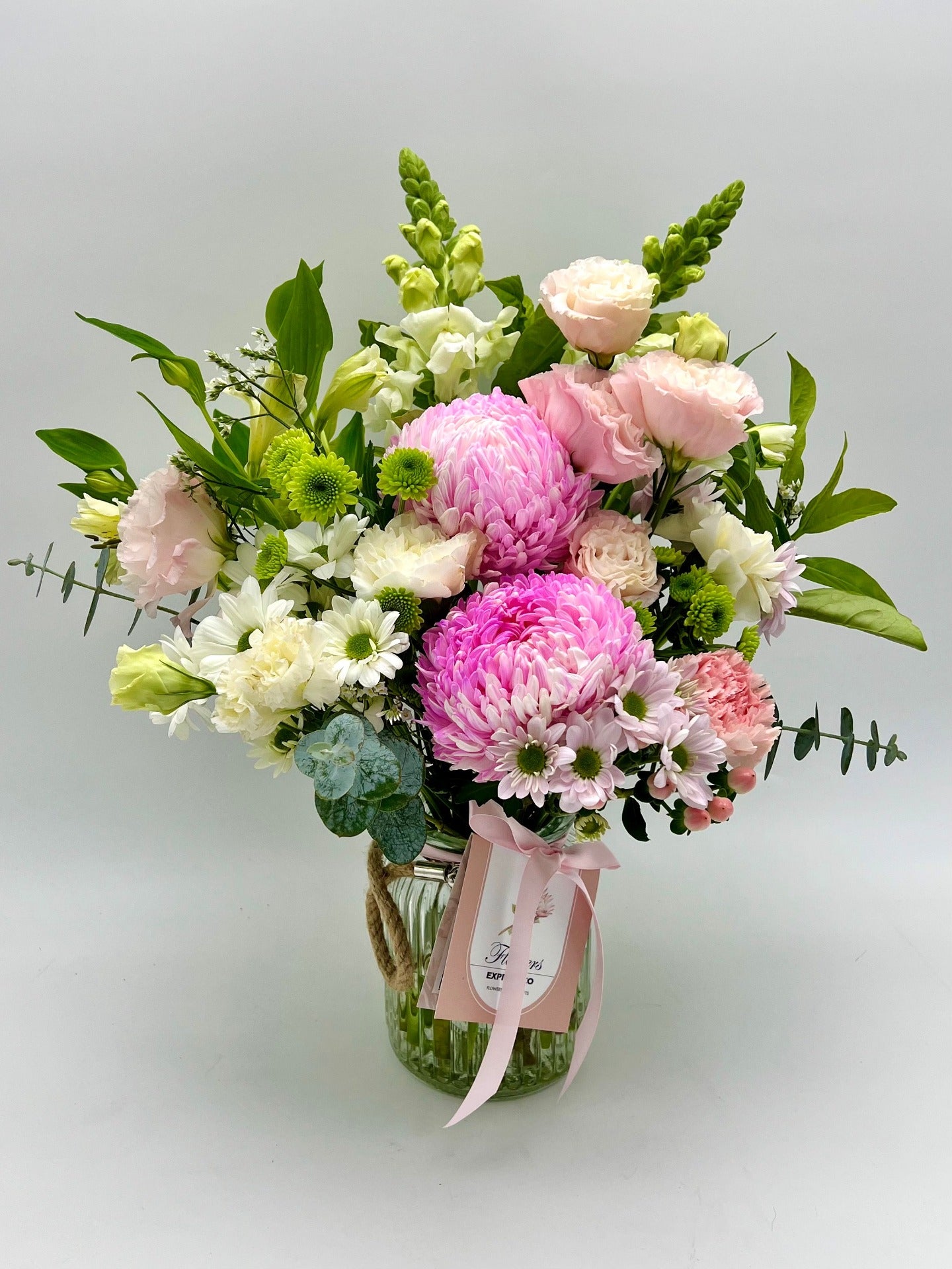 A pink and white flowers bouquet in a vase, made in Melbourne by the florist at Flowers Express Co.