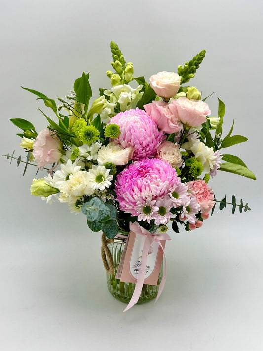 A pink and white flowers bouquet in a vase, made in Melbourne by the florist at Flowers Express Co.