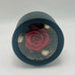 A photo of a preserved red rose, nestled among black and natural flowers in a black gift box. A perfect symbol of everlasting love and beauty.