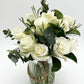 A florist in Melbourne arranged ten white roses and other filler flowers in a glass vase