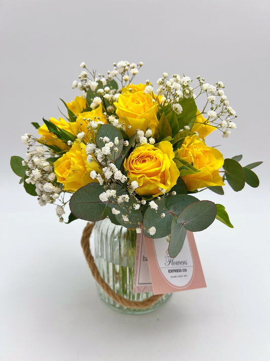 10 stems of yellow roses in a glass jar, delivery in Melbourne.