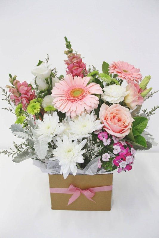 Pink and white flowers arranged in a kraft box with a pink ribbon, perfect for gifting and decorating, available for delivery in Melbourne, VIC.