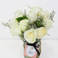 Ten stems of white roses are arranged in a glass jar made by a florist in Melbourne.